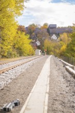 Landscape with railroad tracks, autumn leaves and houses on a hill in sunshine, ZOB Calw, Hermann