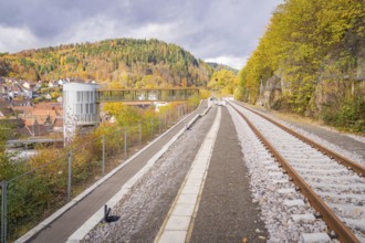 Railway tracks in autumn landscape with views of wooded hills and a city, ZOB Calw, Hermann