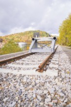 Railway line with rail stopper in autumn landscape under cloudy sky, ZOB Calw, Hermann Hessebahn,