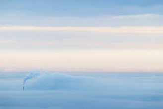 Inversion weather, fog, sunrise, autumn, view from Breitenstein of smoking chimney sticking out of