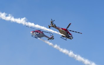 Indian Air Force (IAF) ALH Mk1 Sarang helicopters soar through the sky during an air show as part