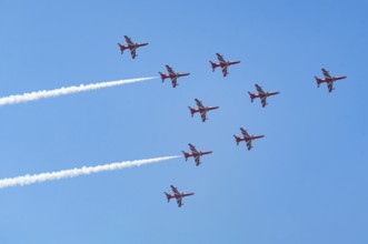 The Indian Air Force (IAF) Surya Kiran aerobatics team performs during an air show as part of the