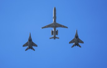 An Indian Air Force Netra AEW&C aircraft flies in formation with two MiG-29 fighter jets during an