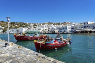 Mykonos, Cyclades, Greece - Colourful fishing boats are moored on the quay in the old port of