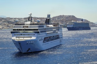 Mykonos, Cyclades, Greece - Cruise ships MEIN SCHIFF 5 and MSC LIRICA are located in the bay off