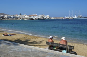 Mykonos, Cyclades, Greece - Tourists and locals like to bathe on the small town beach Paralia Chora