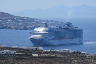Mykonos, Cyclades, Greece - cruise ship MSC Divina sails to Mykonos harbour bay