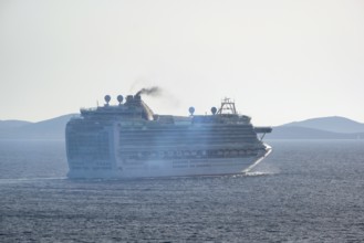 Mykonos, Cyclades, Greece - Cruise ship AZURA from the shipping company P&O Cruises sails out of