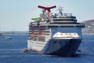 Mykonos, Cyclades, Greece - cruise ship CARNIVAL MIRACLE is located in the bay off Mykonos Town.