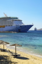 Mykonos, Cyclades, Greece - Voyager of the Seas cruise ship is located in Mykonos Harbour Bay.