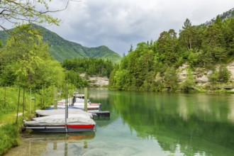 Boats lying on Lake Elisabethsee on a cloudy day in spring, Salzkammergut, Austria