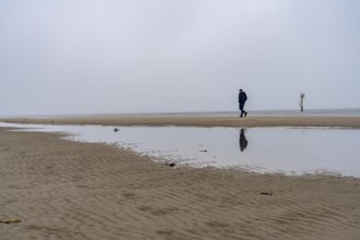 East beach of the East Frisian island of Spiekeroog, beach walk, man alone on the beach, at low