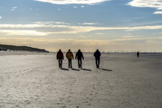 Walkers on the Wadden Sea near the East Frisian island of Spiekeroog, west of the North Sea island,