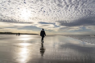 Walkers on the Wadden Sea near the East Frisian island of Spiekeroog, west of the North Sea island,