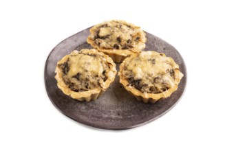 Tartlets with meat and cheese isolated on white background. side view, copy space