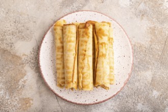 Waffles with caramel on brown concrete background, top view, flat lay, close up