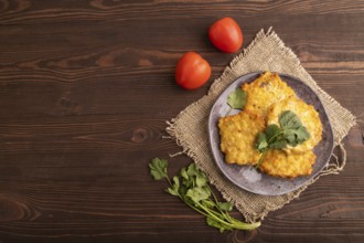 Fried crispy Chicken pancakes on brown wooden background and linen textile. top view, flat lay,