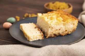 ?ottage cheese ?asserole, Curd cake, with dried apricots and raisins on brown wooden background and