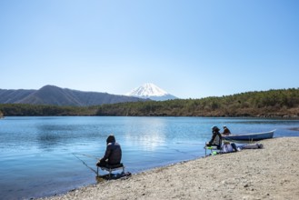 Anglers at Lake Saiko, behind volcano Mt. Fuji, Minamitsuru District, Yamanashi Prefecture, Japan