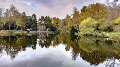 View in autumn across pond at Ehrenmal Pond in the Wittringer Wald recreation area, Gladbeck, North