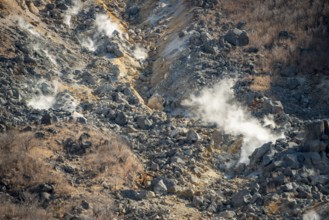 Steaming fumaroles in the Owakudani geothermal area at Komagatake volcano, Hakone, Japan