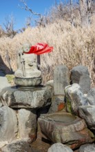 Warm spring water and Buddha statue, Owakudani geothermal area at Komagatake volcano, Hakone, Japan