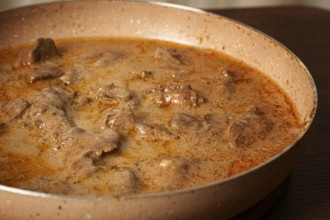 Beef stroganoff, pan cooking, close-up, homemade