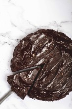 Chocolate cake, round cake, on a marble light table, top view, homemade cakes, no people