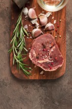 Fresh, raw rib eye steak, on a chopping board, top view, no people