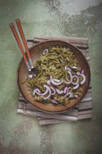 Jonjoli, Colchian klekachka, jonjoli salad, with red onion and butter, Georgian appetizer, pickled