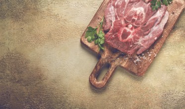 Raw steak, veal neck on the bone, fresh meat, on a cutting board, with spices, top view, without
