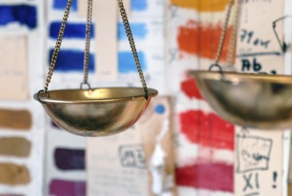Libra hangs in front of colorful color sample cards in an artist studio, Zurich, Switzerland