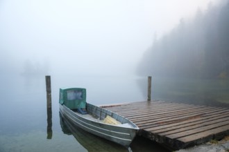 Aluminium boat on a wooden pier at Königssee near fog, Schönau am Königssee, Berchtesgadener Land,
