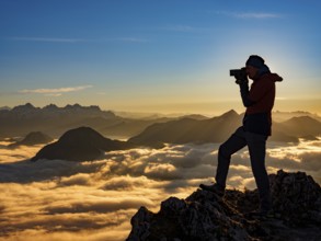 Photographer in evening light at the summit, view of an alpine panorama, Hochstaufen, Chiemgau