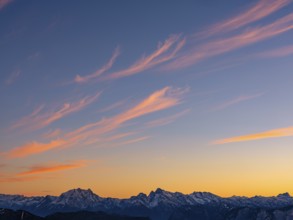Red-colored plume clouds over the Berchtesgaden Alps at dusk, Hochstaufen, Chiemgau Alps, Upper