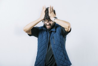 Unhappy man with headache concept. Painful man with a migraine holding his head isolated