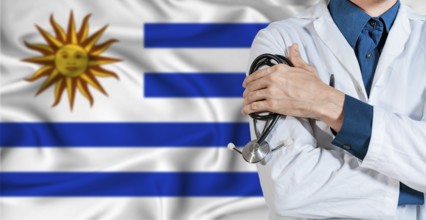 Uruguay healthcare concept. Doctor with stethoscope on Uruguay flag. Doctor holding stethoscope on