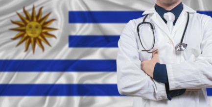 Male doctor with stethoscope on Uruguay flag. Doctor holding stethoscope on Uruguay flag