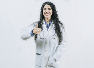 Smiling doctor approving something isolated. Female doctor gesturing OK isolated