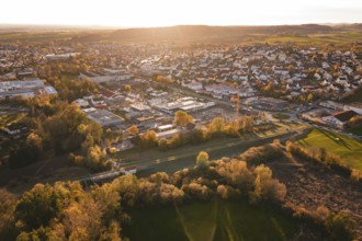 Panorama of a city with residential areas and autumn landscape in evening light, Grossbottwar,
