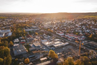 Small town with industrial facilities in warm evening autumn light, Grossbottwar, Germany