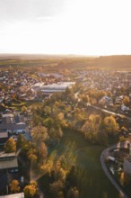 View of small town with lots of trees and autumn light at sunset, Grossbottwar, Germany