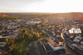 View over the rooftops of a city in autumn evening with lots of nature, Grossbottwar, Germany