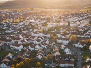 Dense residential area with autumn colors and festive sunset light, Großbottwar, Germany