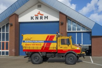 KNRM Mercedes-Benz Unimog 435 truck in front of sea search and rescue lifeboat station at