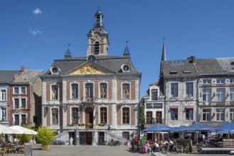 Pavement cafés and 18th century town hall at the Grand Place in the city Huy in summer, province of