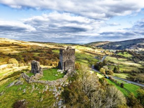 Autumn colours over Castell Dolwyddelan and Eryri Mountains from a drone, Snowdonia, Conwy County