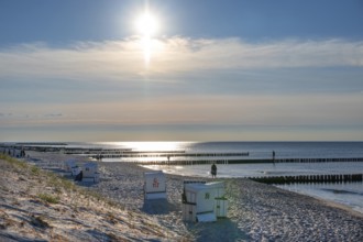 Grooches in the Baltic Sea and beach chairs, the sun against light, Ahrenshoop, Darß,