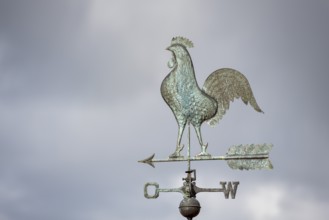 Close-up of a rooster weather vane against a cloudy sky, Baden-Württemberg, Germany