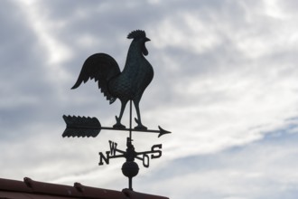 Weathercock silhouette against cloudy sky, looks mysterious, Baden-Württemberg, Germany